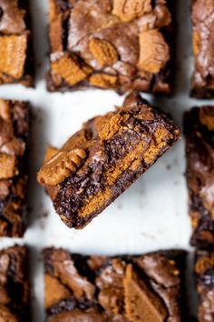 a close up of some brownies on a white surface with chocolate chips and peanut butter