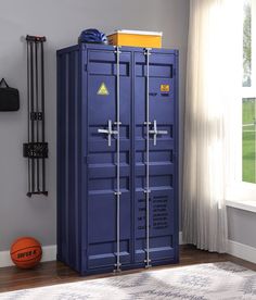 a large blue locker sitting in the corner of a room next to a basketball ball