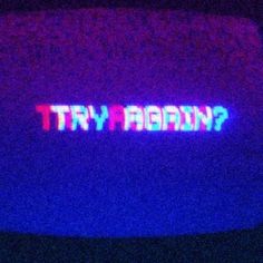 the word'try again?'is lit up in purple and blue colors on a television screen