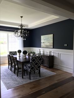 a dining room table with chairs and a chandelier