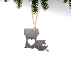 a metal ornament shaped like the state of new hampshire hanging from a christmas tree