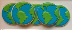 four decorated cookies with the earth on them