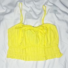 Bright Yellow Crop Top With Spaghetti Straps And A Bow Detail On The Front. Brand New With Tags. *Smoke-Free Home Yellow Camisole Crop Top For Summer, Trendy Cotton Camisole For The Beach, Yellow Camisole Crop Top For Spring, Trendy Beach Tops With Spaghetti Straps, Yellow Spaghetti Strap Tank Top For Summer, Yellow Spaghetti Straps Tank Top For Summer, Trendy Spaghetti Strap Beach Tops, Trendy Spaghetti Strap Tops For Beach, Cotton Spaghetti Strap Camisole For Beach Season