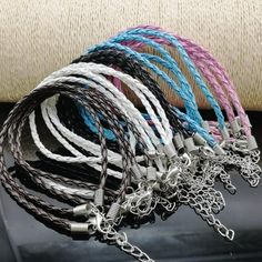 a bunch of bracelets that are on top of a car seat belt with chains attached to them