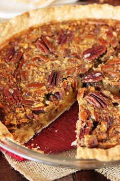 a pecan pie with one slice cut out and ready to be eaten on the table