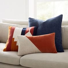 pillows on a couch in front of a window