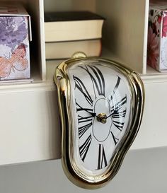 a clock that is on the side of a shelf