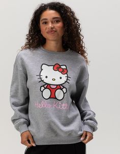 Sanrio Hello Kitty Crewneck Sweatshirt. Large Hello Kitty Graphic Screened On Front. Ribbed Crew Neckline. Cuffed Long Sleeves And Hem. Fleece Lining. 60% Cotton, 40% Polyester. Machine Wash. Imported.officially Licensed Model Is Wearing A Size Small. Model Measurements:height: 5'7" Bust: 32cwaist: 24"hips: 35" Hello Kitty Print Top For Winter Streetwear, Trendy Hello Kitty Print Crew Neck Top, Casual Cotton Sweatshirt With Hello Kitty Print, Trendy Hello Kitty Print Crew Neck Sweatshirt, Casual Hello Kitty Crew Neck Top, Casual Hello Kitty Sweatshirt For Streetwear, Cute Hello Kitty Print Crew Neck Sweatshirt, Hello Kitty Print Crew Neck Top For Winter, Hello Kitty Print Crew Neck Top For Streetwear