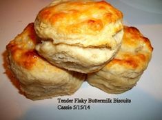 three biscuits stacked on top of each other with the words tender flaky buttermilk biscuits