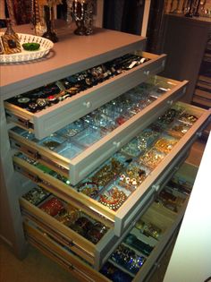 an open drawer in a kitchen filled with jewelry