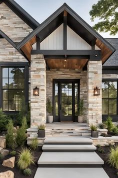 a large house with stone and wood trimming on the front door, steps leading up to