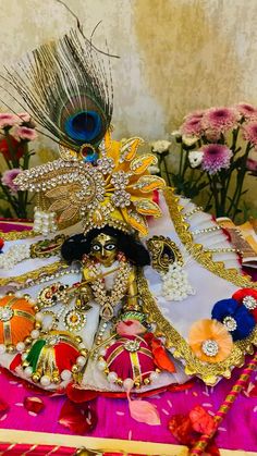 an elaborately decorated display with flowers in the background