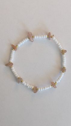 The bracelet is about 7 inches long and made with glass seed beads, and peach jade beads. Handmade Peach Bracelets With Round Beads, Handmade Peach Beaded Bracelets As Gift, Handmade Peach Beaded Bracelets For Gift, White Czech Glass Beaded Bracelets With Colorful Beads, Handmade White Beaded Bracelets With Oval Beads, White Beaded Bracelets With Colorful Czech Glass Beads, White Beaded Crystal Healing Bracelet, White Beaded Crystal Bracelet For Healing, Adjustable White Bracelet With Oval Beads