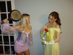 two women dressed up as princesses and one is holding a rose in her hand