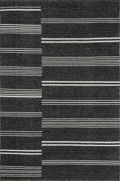 a black and white rug with vertical stripes