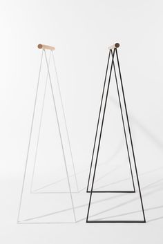 two black and white metal stands with wooden handles on each side, against a white background