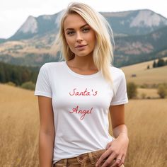 White Santa's Angel Tee Classic t-shirt with a slim feminine fit, crew neck and short sleeves. Made from superior combed and ring-spun cotton. . .: 100% airlume combed and ringspun cotton (fiber content may vary for different colors) .: Light fabric (4.2 oz/yd² (142 g/m .: Slim fit with longer body length .: Tear away label .: Runs smaller than usual Fitted Short Sleeve Christmas Top, Fitted Crew Neck T-shirt As A Gift, Fitted White T-shirt As Gift, Fitted Short Sleeve Tops Gift, Fitted Short Sleeve Tops For Gift, Christmas Gift For Her, T Shirt For Women, Shirt For Women, Christmas Gifts For Her