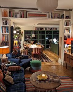 a living room filled with furniture and bookshelves