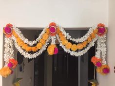 an entrance decorated with flowers and garlands