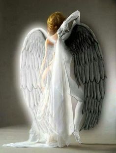 an angel with white and black wings standing in front of a wall