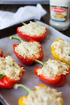 some stuffed peppers are on a baking sheet