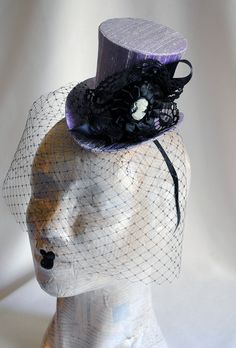 This victorian goth mini top hat is a simple yet elegant piece.It is covered with black silk shantung and adorned with black satin ribbon in a vertical half bow, vintage black cotton lace in a rosette, pleated satin ribbon, which forms an oval frame for a beautiful black and white victorian profile cameo. Choose between with or without black veil. Also available in a white and black combination: https://www.etsy.com/bizarrenoir/listing/166826619/gothic-mini-top-hat-in-purple-velvet?ref=shop_home Fitted Halloween Evening Hats, Fitted Hats For Halloween Evening, Steampunk Brimmed Mini Hats For Halloween, Gothic Costume Hat With Round Crown For Costume Party, Elegant Top Hat For Halloween Party, Elegant Fitted Halloween Costume Hats And Headpieces, Gothic Fitted Brimmed Top Hat, Fitted Gothic Brimmed Top Hat, Fitted Gothic Costume Hats For Halloween