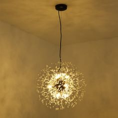 a chandelier hanging from the ceiling in a room with white walls and flooring