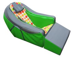 a child's recliner that is green and grey with polka dots on it