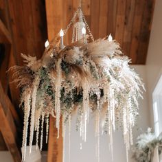 a chandelier hanging from the ceiling in a room with wood paneling and white walls