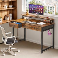 a desk with a computer on it and a chair in front of the window next to it