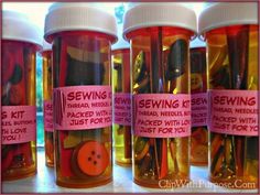 several jars filled with sewing supplies on top of a table