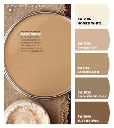 some brown and white paint colors on a table with a cup of coffee next to it