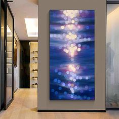 a painting hanging on the wall in a hallway