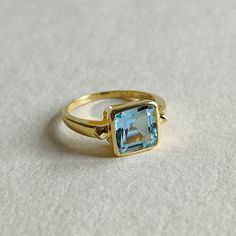 ITEM DESCRIPTION: >> The Ring is made from Solid 14K Yellow Gold. Gemstone used is absolutely natural and ethically sourced.  >> Natural Sky blue topaz in square octagon shape is studded on it with utmost precision.  >> This is a minimalist design which makes it a hassle free and everyday jewelry. Gem: Sky Blue Topaz Gem size: 8x8 mm square octagon Gem weight: 2.95 CT Gold purity: 14K (58.33% approx.) Gold weight: 2.01 grams  Gross weight : 2.60 grams The Gold purity is guaranteed and it comes w Sky Blue Topaz Ring, Gold Skies, Blue Topaz Jewelry, Handmade Jewelry Box, Octagon Shape, Zierlicher Ring, Sky Blue Topaz, December Birthstone, 14k Gold Ring