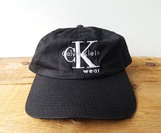 Original vintage 90's Calvin Klein Official Licensed promotional unstructured slouch snapback hat!   One Size Fits Most Adults up to size 7 5/8  (Low profile) Condition: Excellent - Lightly or never worn. Here's a shortcut to view more of our dad hats:   https://www.etsy.com/shop/HatsForward/items?ref=listing-shop2-all-items-count&search_query=dad%2Bhat ..and if you're purchasing more than one we automatically combine shipping costs to save you more! 90s Calvin Klein, Ck Logo, Vintage Names, Cotton Gifts, Dad Hat, Ball Cap, Trucker Cap, Snapback Hats, Dad Hats