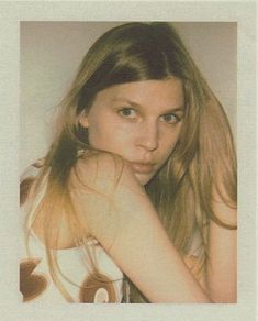 a woman with long hair posing for a photo