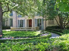 a large house surrounded by trees and bushes