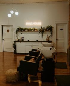 a salon with chairs and plants on the wall