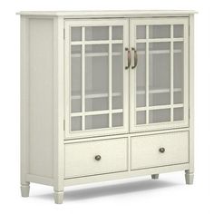 a white cabinet with glass doors and drawers