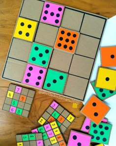 several different colored squares and numbers on a wooden table