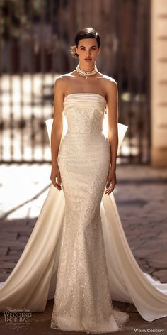 a woman in a white wedding dress posing for the camera