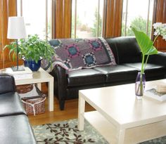 a living room filled with black leather furniture