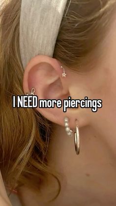 a girl with ear piercings that says i need more piercings