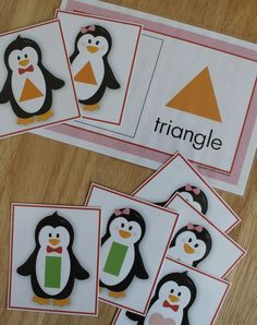 four penguin matching cards on a table with the word triangle in front of them,