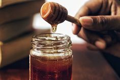 a honey jar filled with liquid sitting on top of a table