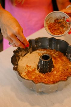 cinnamon brown sugar mixture is being placed on top of the cake batter Cinnamon Brown