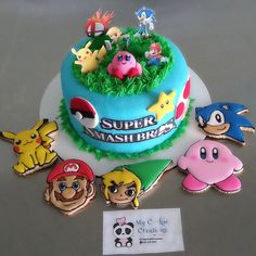 there is a cake decorated with cartoon characters on the top and bottom, along with other decorations