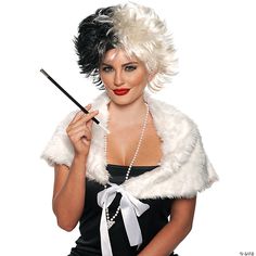 a woman in a black dress and white fur stoler holding a wand while posing for the camera