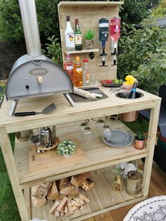 an outdoor bbq grill with lots of cooking items