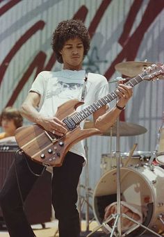 a man playing an electric guitar on stage